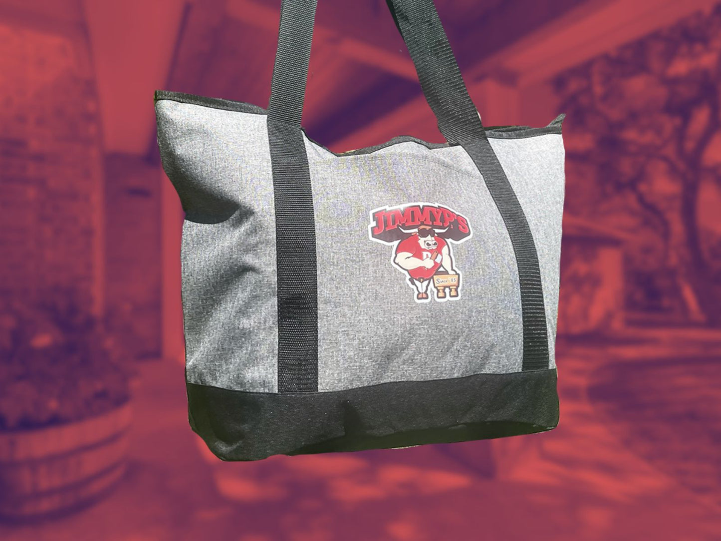 A cooler gift bag with a logo on it, presumably containing food items as part of a meal bundle.