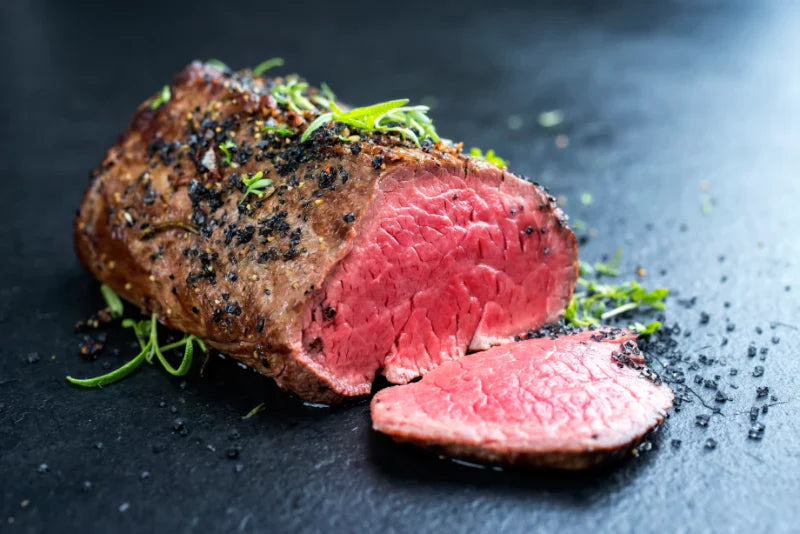 Colombian-style Lomo al Trapo beef tenderloin sliced after being grilled in a salt crust over hot charcoal.