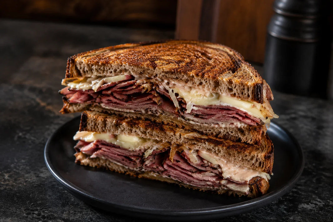 Smoked Wagyu pastrami Reuben with Swiss cheese, sauerkraut, and caramelized apple and onion